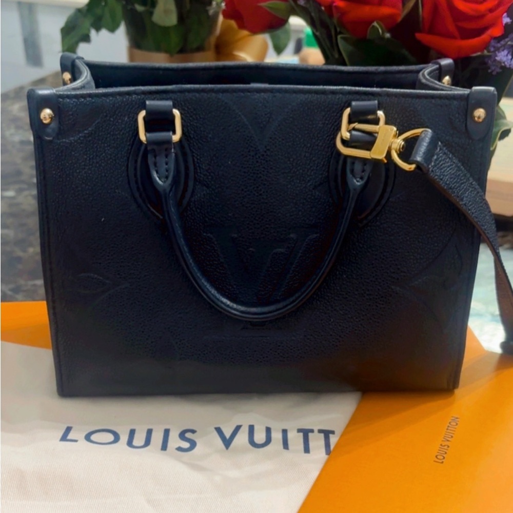 Louis Vuitton black on the go pm Handbag with Gold Accents
